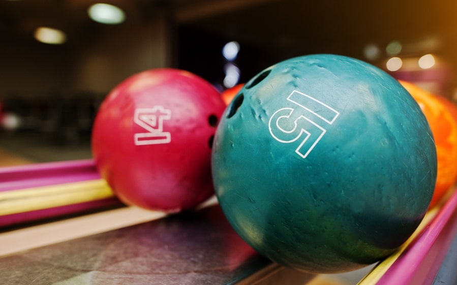 Two colored bowling balls of number 15 and 14